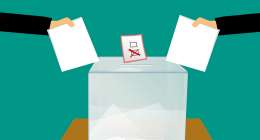 Ballots being put in a box.