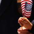 Child waves American flag.