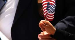 Child waves American flag.