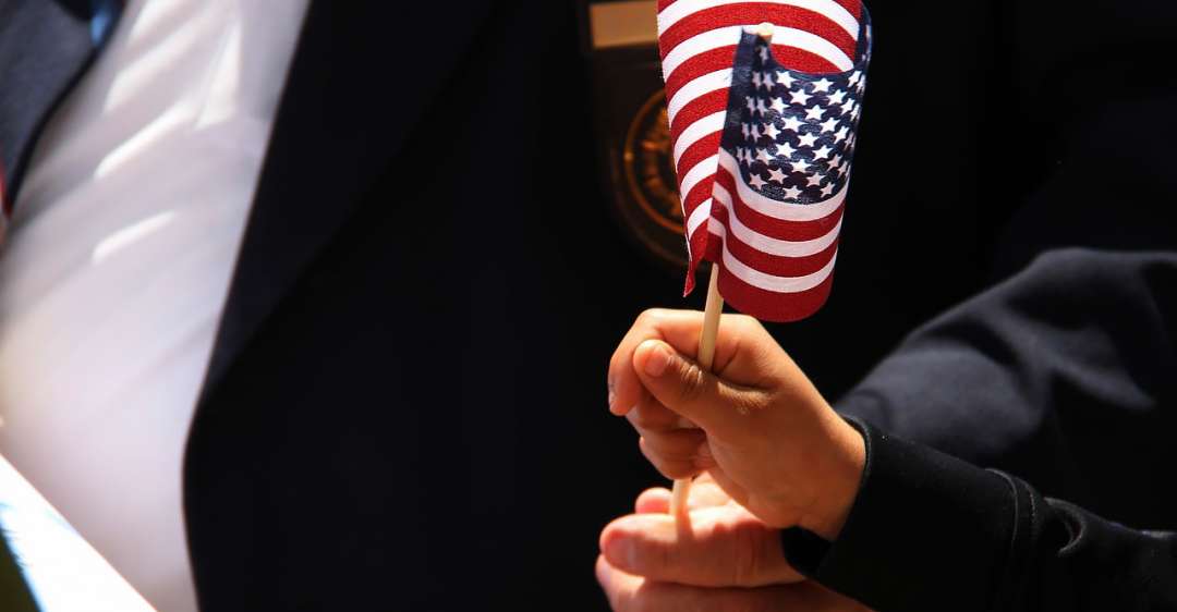 Child waves American flag.