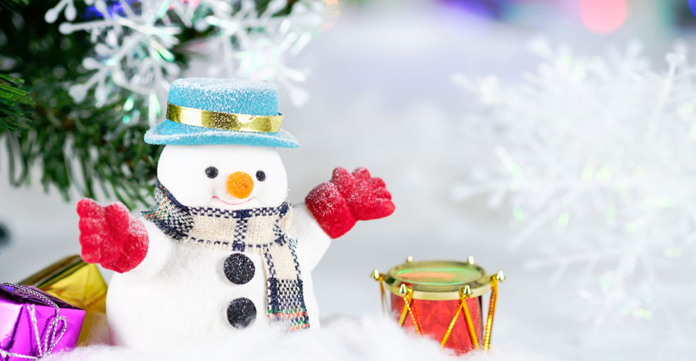 Little Snowman In Front of Christmas Tree