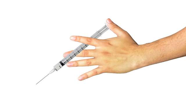 Hand holding needle.