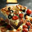 Pizza slice being picked up.