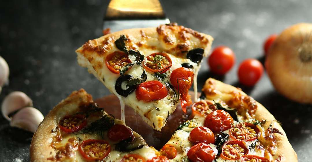 Pizza slice being picked up.