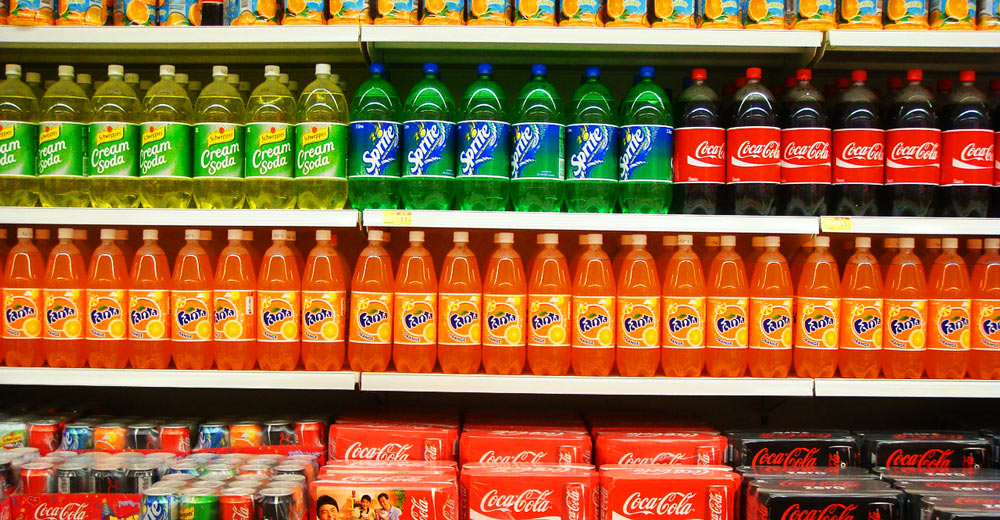 Aisle filled with soda.
