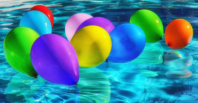 Colored balloons in pool.