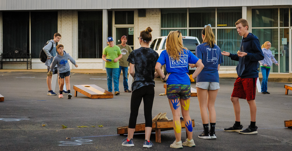 Competing in another round of a cornhole competition.