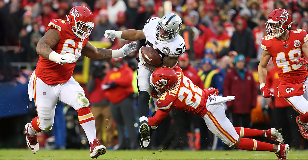 KANSAS CITY, MO - DECEMBER 01: Kansas City Chiefs free safety Juan Thornhill (22) tackles Oakland Raiders running back DeAndre Washington (33) during a kickoff return in the second quarter of an AFC West game between the Oakland Raiders and Kansas City Chiefs on December 1, 2019 at Arrowhead Stadium in Kansas City, MO. (Photo by Scott Winters/Icon Sportswire)