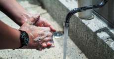 Washing hands with soap and water.