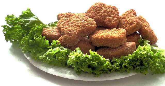 Chicken nuggets on lettuce.