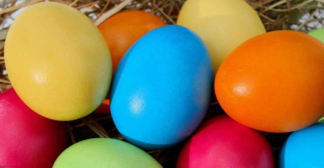 Colored Easter eggs in hay.