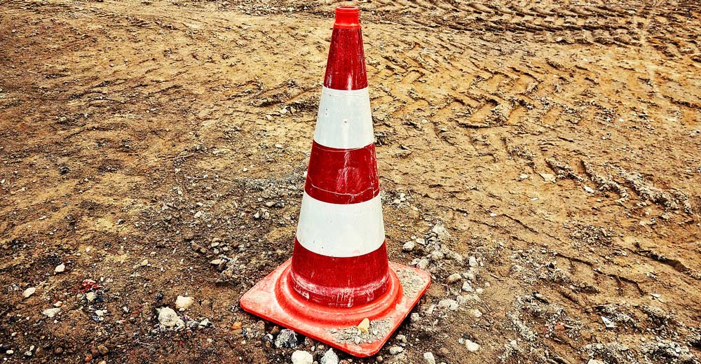 Construction cone in dirt.