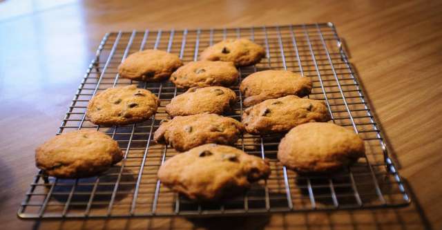 Chocolate chip cookies on a cooling rack.