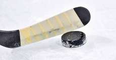 Hockey stick hitting puck.