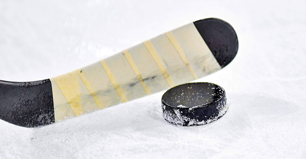 Hockey stick hitting puck.