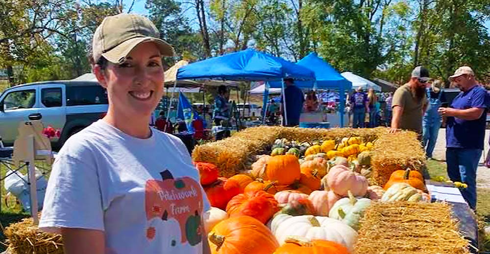 Stefanie Hobson of Patchwork Farms shows off her beautiful pumpkins, squash and mums.