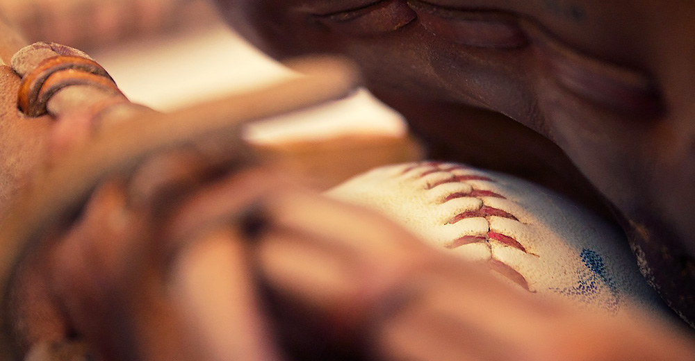 A baseball in side of a mitt
