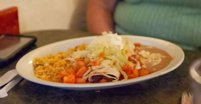 Jason's Mexican Restaurant burrito and toppings and sides on plate.