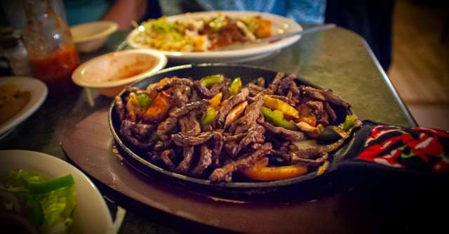 Jason's Mexican Restaurant Fajita meat in skillet.