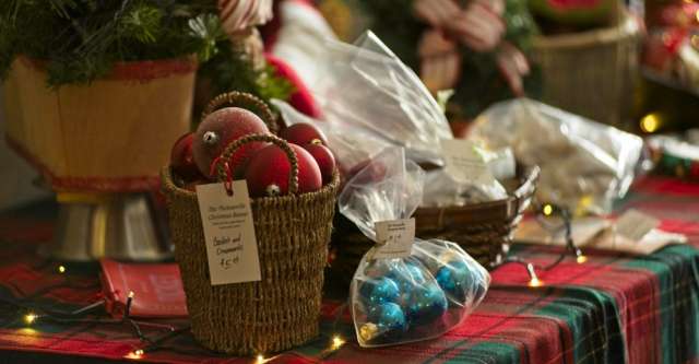 A basket and bag of red and blue ornaments.
