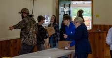 People handing the food boxes from one person to the next at the Alton Food Bank on December 1, 2021.