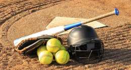 Softballs with helmet, glove, and bat.
