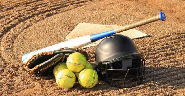 Softballs with helmet, glove, and bat.
