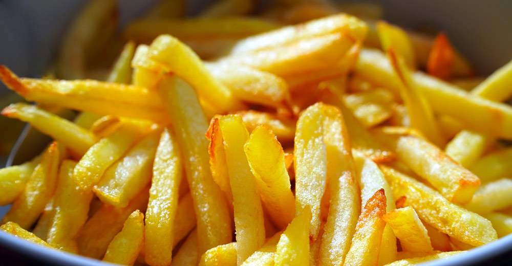 A bowl of golden brown French fries.