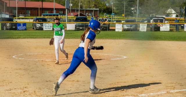 ALTON, MO – APRIL 26: Alton Comets batter runs to the base after hitting the ball during the high school softball game between the Alton Comets and the Thayer Bobcats on April 26, 2022, at the Alton High School softball field in Alton, MO. (Photo by Amanda Thomas/AltonMo.com)