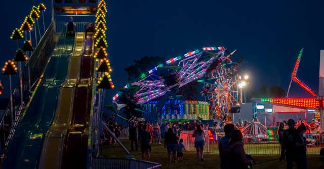 The spinning rides and Fun Slide at night at the Heart of the Ozarks Fair on June 7, 2022.