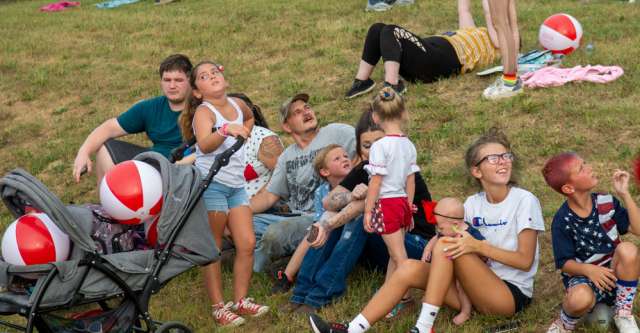 People looking at skydivers on 4th of July