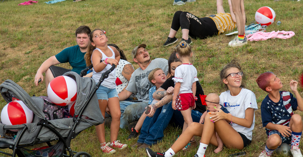 People looking at skydivers on 4th of July
