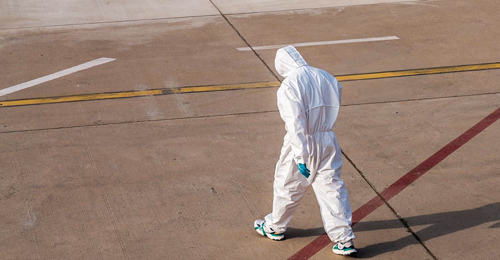 Man in hazmat suit walking