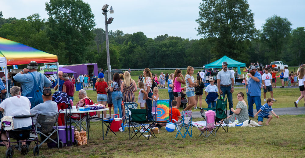 A couple of families chatting together at the Alton Independence Day celebration on July 3, 2023.