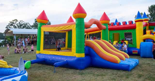 Kids playing in the inflatable bouncy house at the Alton Independence Day celebration on July 3, 2023.