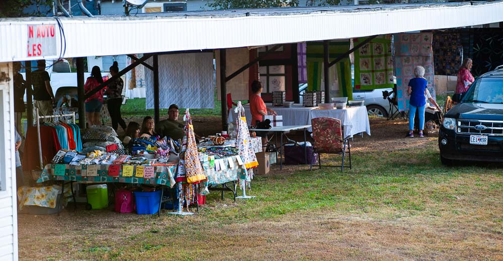 Vendors selling raffles, aprons, jewelry, and more set up under an awning at the Myrtle Yester-Daze event on September 30, 2023.