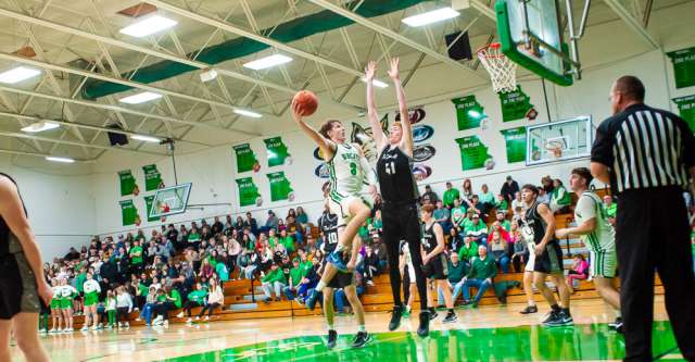 THAYER, MO – DECEMBER 18: Thayer Bobcats Devin Harrington (3) soars through the air with the ball to get a two-pointer during the high school basketball game between the Thayer Bobcats and the Izard County Cougars on December 18, 2023 at the Thayer High School Gym in Thayer, Missouri. (Photo by Amanda Thomas/AltonMo.com)