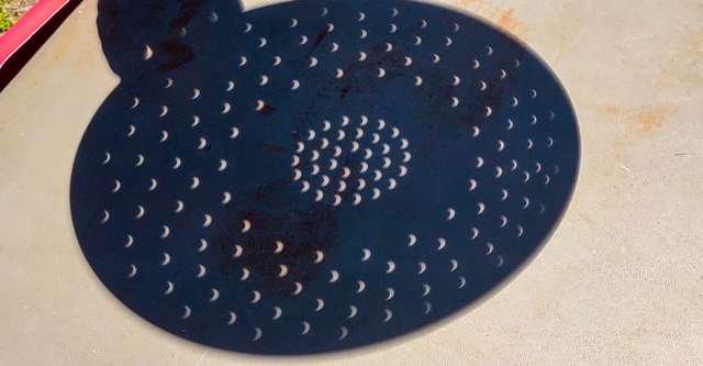 Eclipse through colander holes