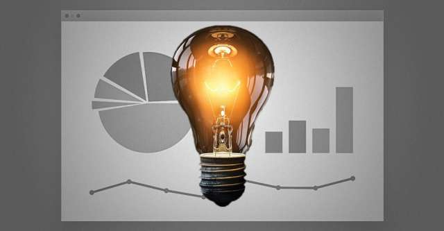 A light bulb with graphs behind it.