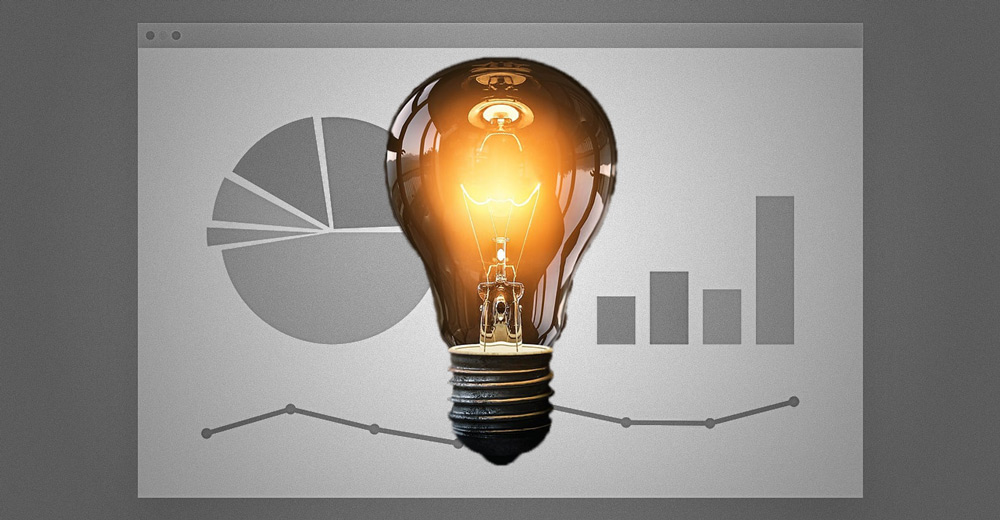 A light bulb with graphs behind it.