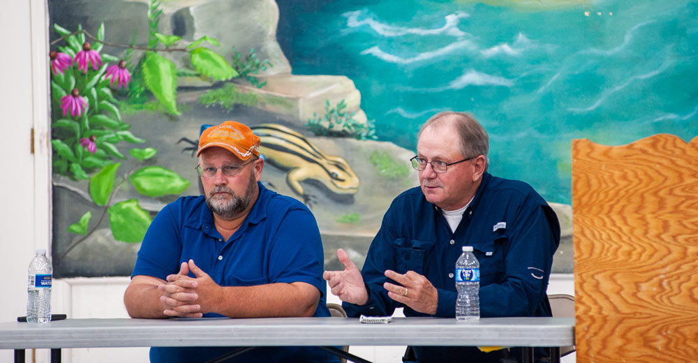 (Left) Dennis Morgan, southern county commissioner for Oregon County, and David Stubblefield, Oregon County commissioner, listens after the meeting is started.