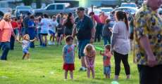 Little kids playing with a Frisbee from Riverton Baptist Church at the Independence Day celebration in Alton.