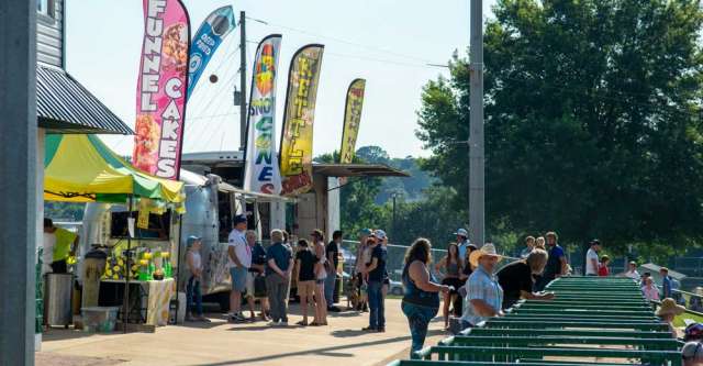 Food vendors lined up on the pavement for the attendees.