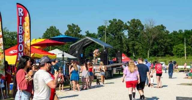 Individuals milling about at Thayer's fireworks.
