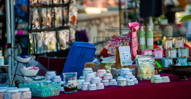 Body soaps, perfume, and lotions being sold at a booth.