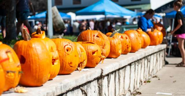Carved pumpkins lining the courthouse wall.