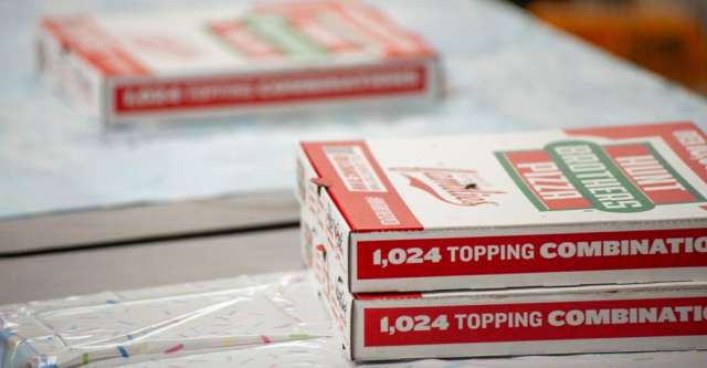 Pizza being served on a table.