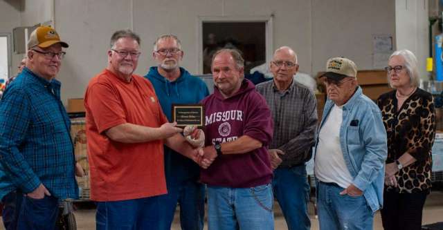 The Board of Directors presenting Herman Holmes with a plaque for his 38 years of service.