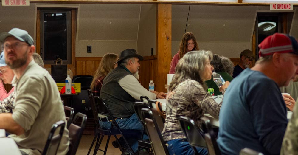 Individuals eating the food at the Hunter's Meal.