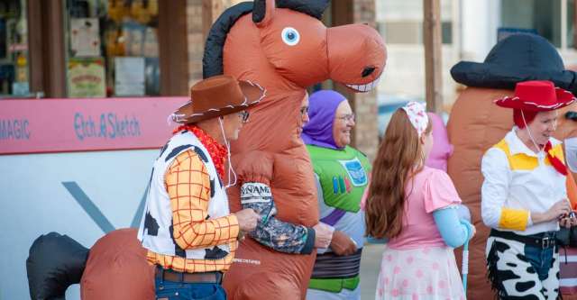 The Toy Story group handing out candy in front of Young's Produce.